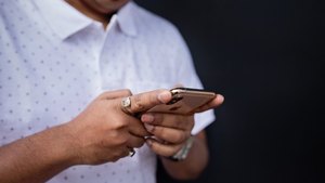 Close-up of a man's hands holding a phone