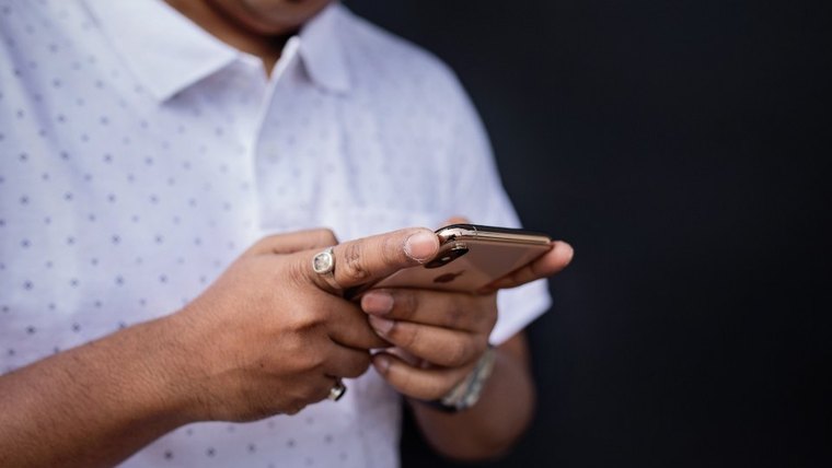 Close-up of a man's hands holding a phone
