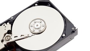 An opened hard disk drive with the platter and the read head arm visible